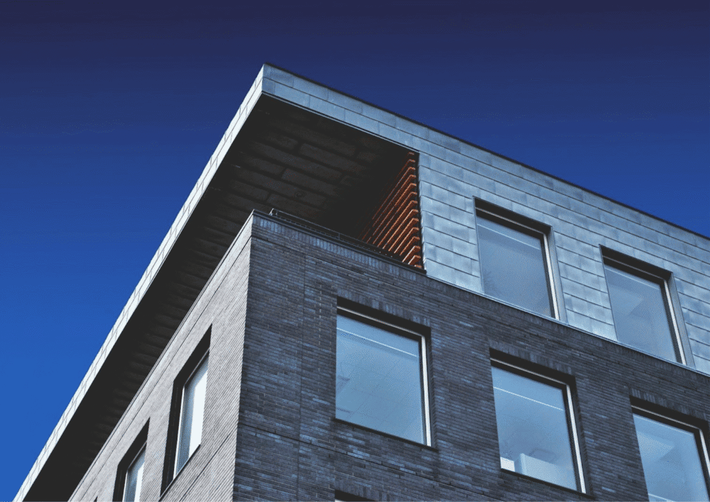 Modern building facade, angular, with blue sky behind it